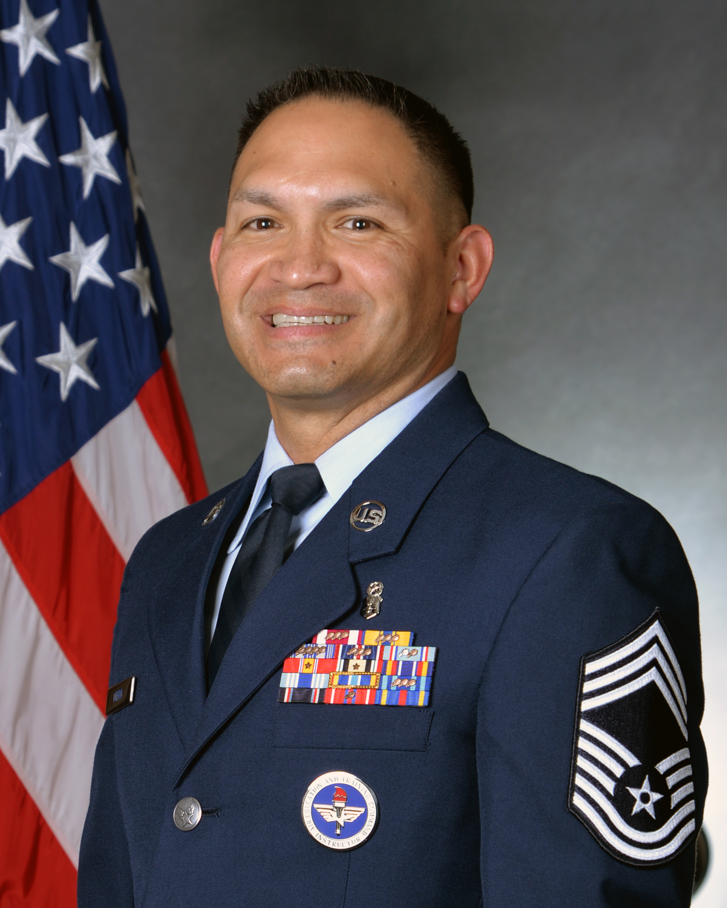 Official headshot with U.S. flag in background of CMSgt Ernesto Otero